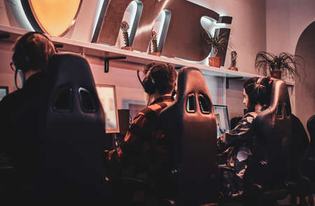 Photo of teenagers wich are playing videogames at popular championship.の写真素材