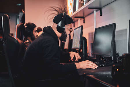 Photo of cyber sport progress - team of teenagers are playing videogames.の写真素材