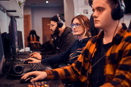 Adult tired boys and girl are playing videogames at popular cyber championship.の写真素材