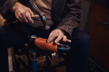 Closeup photoshoot of man making comfortable hand made shoes for people.