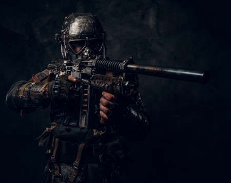 Cool cosplay costume of post - apocalypse knight, man is posing at dark photo studio.の写真素材