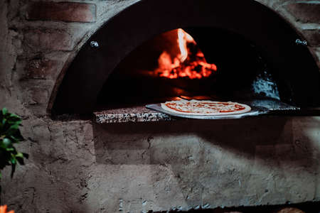 Italian chef make Tasty stone baked pizza .の写真素材