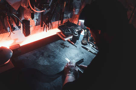In the busy workshop a talanted master is working on his new project.の写真素材