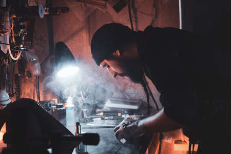 In the busy workshop a talanted master is working on his new project.