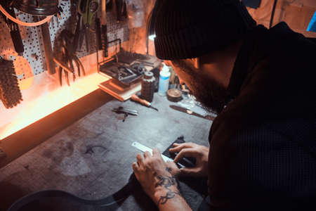 In the busy workshop a talanted master is working on his new project.