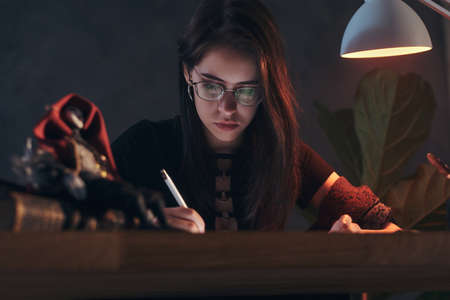 Young pretty girl is making a skeches for her new project.の写真素材