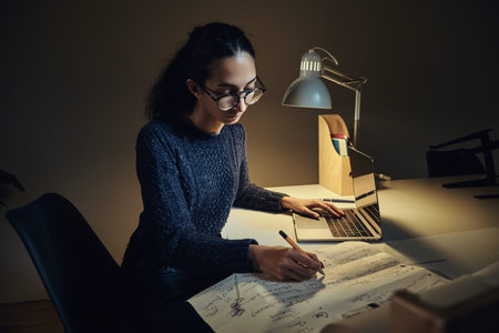 Attractive business woman is making her daily routine while working at her office.