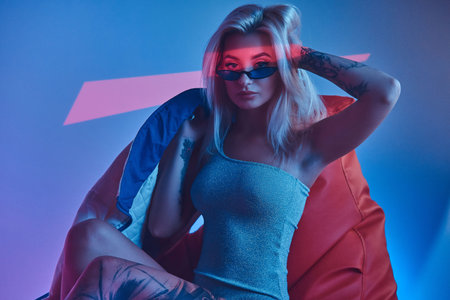 Young attractive woman is posing for photographer at photo studio.