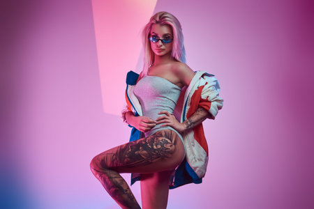 Fashionable photo of attractive model in stylish jacket and sunglasses.
