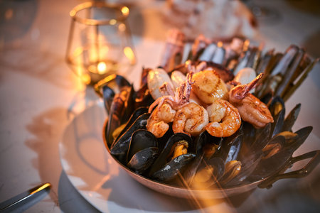 A full dinner rich ceramic bowl of prepared grilled shrimps and mussels including tiny octopus...
