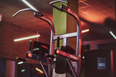 Metallic parallel bar machine standing in an empty modern fitness center. Sportive gym equipment.の写真素材