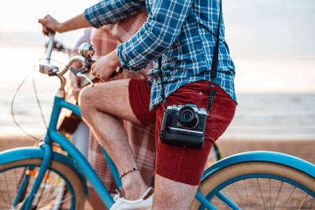 Friends are spending their time on the beach, cycling and having funの写真素材