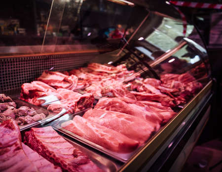 Healthy fat meat store. Many of cool raw meat pieces in fridge. Meat selling business.の写真素材