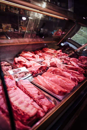 Full-filled with cool red meat shop window. Meat selling. Butchers shop with huge meat types.の写真素材