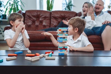 Youth and joyful brother have a good time competing each other and playing  game. Relaxed domestic lifestyle of family.の写真素材