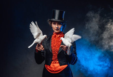 Mysterious circus actress holding two little doves on her hands in smoke