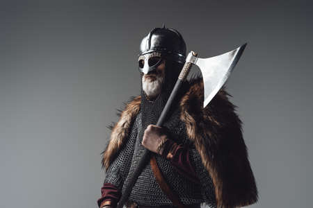 Side view studio shot of old man viking with axeの写真素材