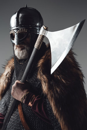 Side view studio shot of old man viking with axeの写真素材