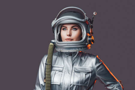 Woman astronaut wearing space helmet and suitの写真素材