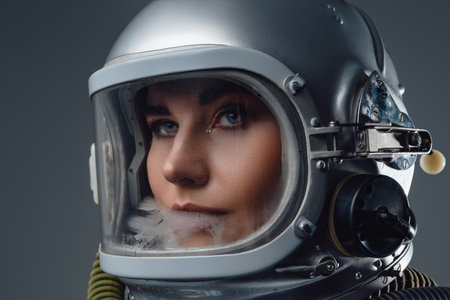 Headshot of modern spacewoman dressed in spacesuitの写真素材