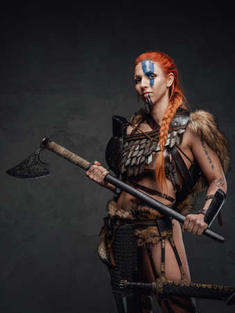 Norway woman barbarian wearing armor and holding a huge axeの写真素材
