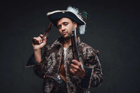 Cool pirate with handguns against dark backgroundの写真素材