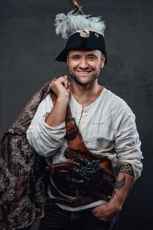 Joyful pirate with cocked hat holding jacketの写真素材