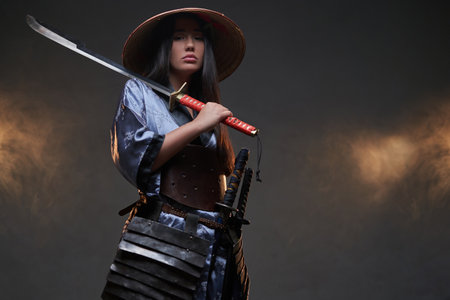 Attractive woman in japanese samurai style with katanaの写真素材