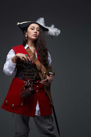 Dangerous female corsair with wavy hairs wearing costume