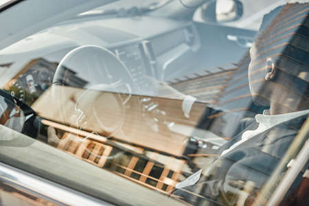 Businessperson of african descent sitting inside car