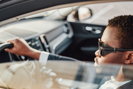 Serious african american businessman inside of car