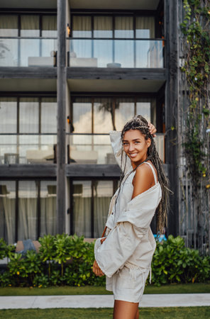 Happy woman in bali posing against mansion