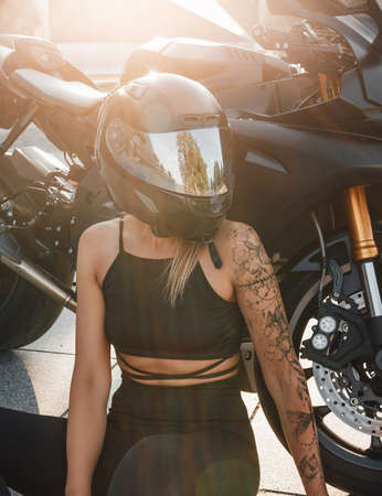 Shot of woman with helmet and motorbike looking awayの写真素材