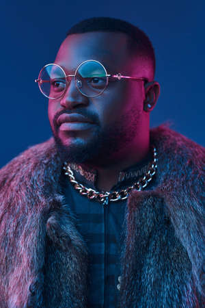 Portrait of black man with glasses and fur coatの写真素材