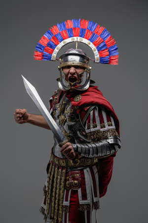 Screaming roman soldier dressed in steel armor and plumed helmetの写真素材