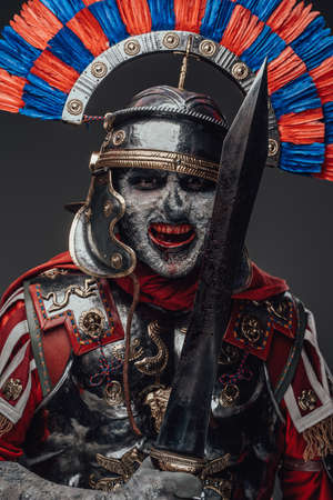 Violent zombie centurion staring at camera isolated on grayの写真素材