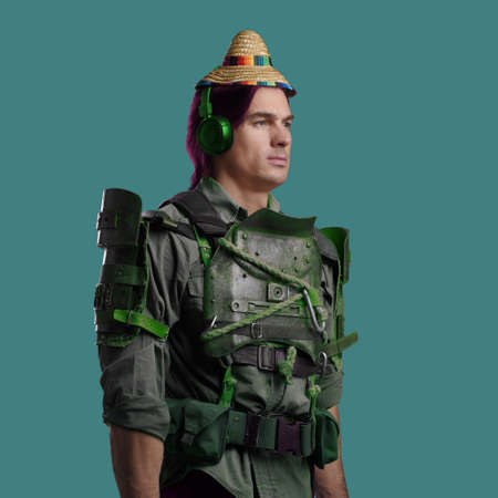Fashionable guy dressed in armor posing against colorful backgroundの写真素材