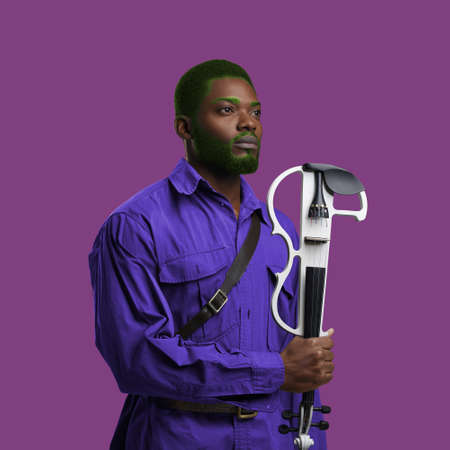 African guy dressed in hipster clothing against colorful backgroundの写真素材