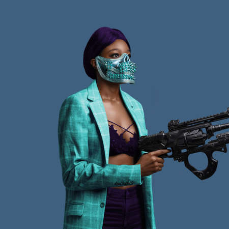 Black woman with gun dressed in trendy colorful clothingの写真素材