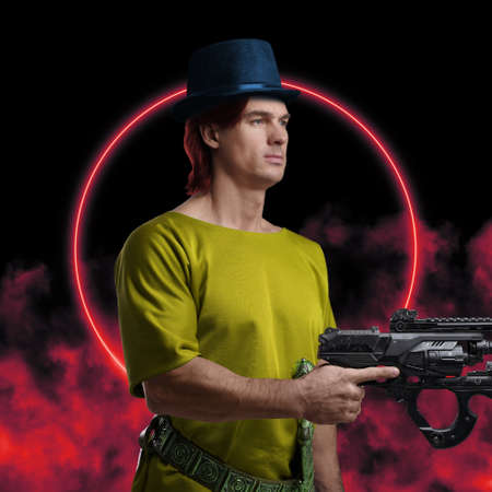 Bizarre guy with gun and hat dressed in yellow shirt