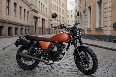 Old fashioned dark colored bike on alley in townの写真素材