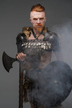 Redhead viking with scar holding shield and axe