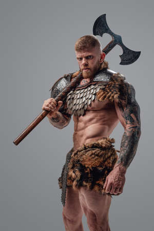 Violent viking with muscular build and axe on his shoulderの写真素材