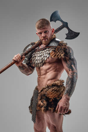 Formidable viking with strong body holding two handed axeの写真素材