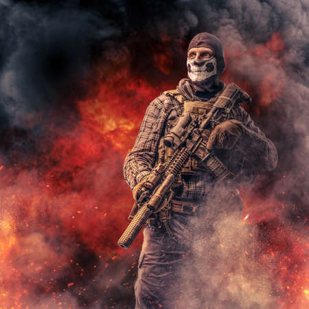 Brave soldier with rifle against fire explosions and smoke