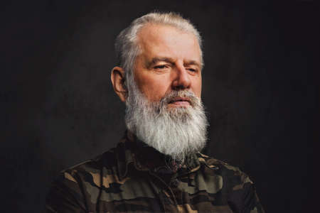 Headshot of elderly man dressed in camouflage suit