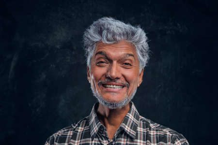 Handsome old man smiling and looking at camera