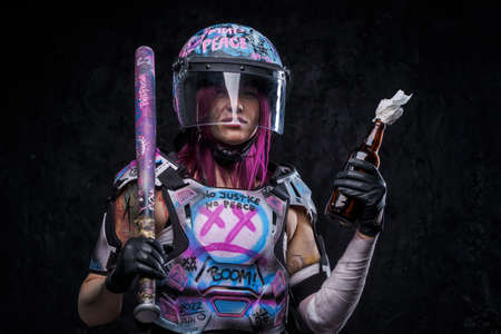 Outlaw woman protester with molotov cocktail against dark background
