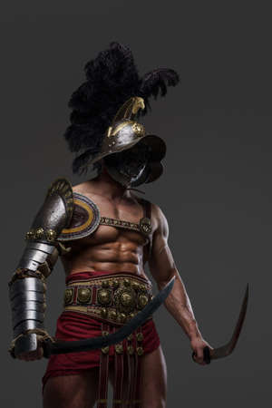 Combative roman gladiator with plumed helmet and two swordsの写真素材