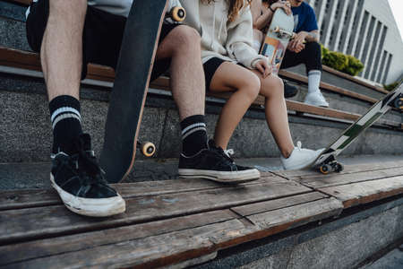 Shot of hipster group people with skateboards outdoorsの写真素材